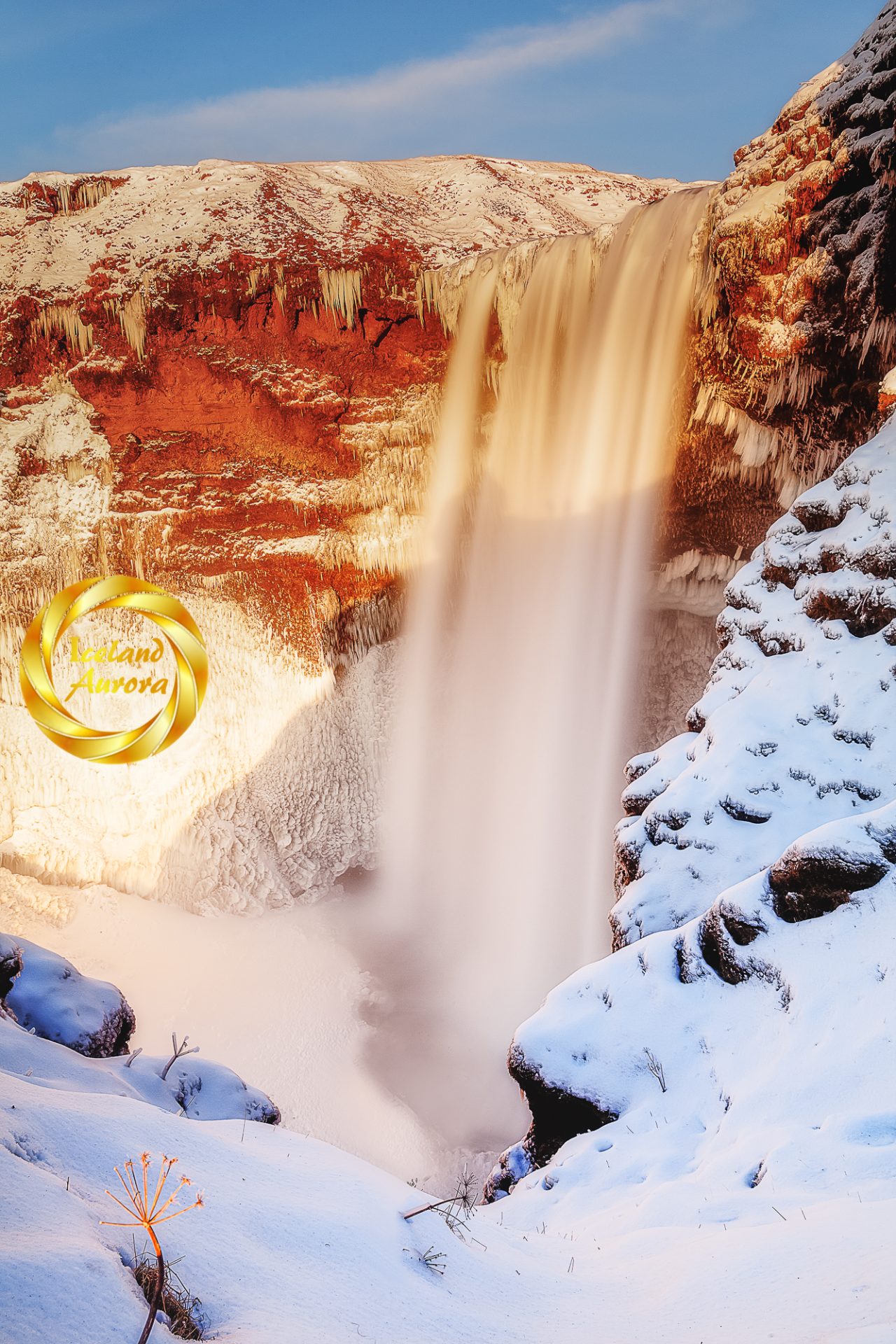 Skogafoss waterfall winter vertical