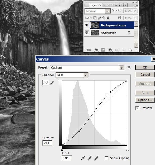 Apply a stronger contrast curve to your top layer.