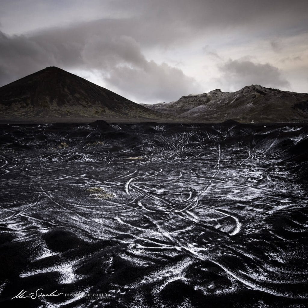 Snow and black sand in the Icelandic mountains